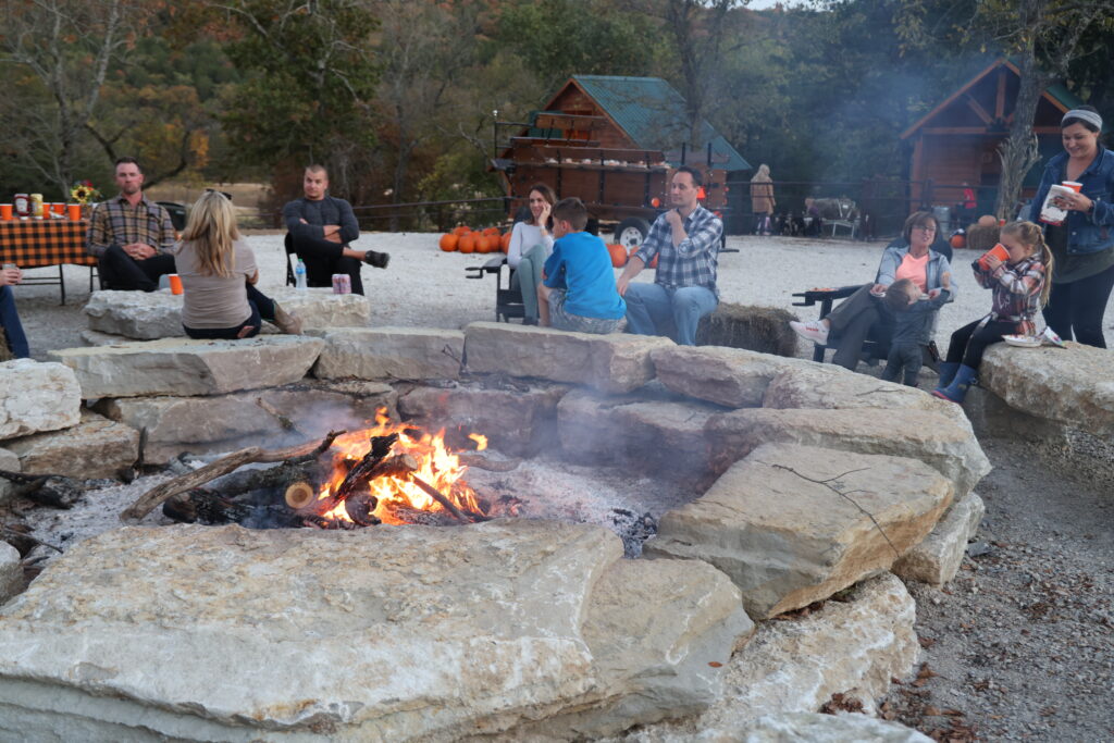 dude ranch guests around fire pit