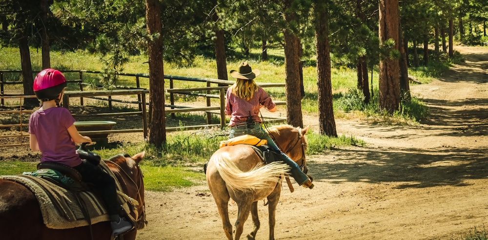 instructor with student on trail ride