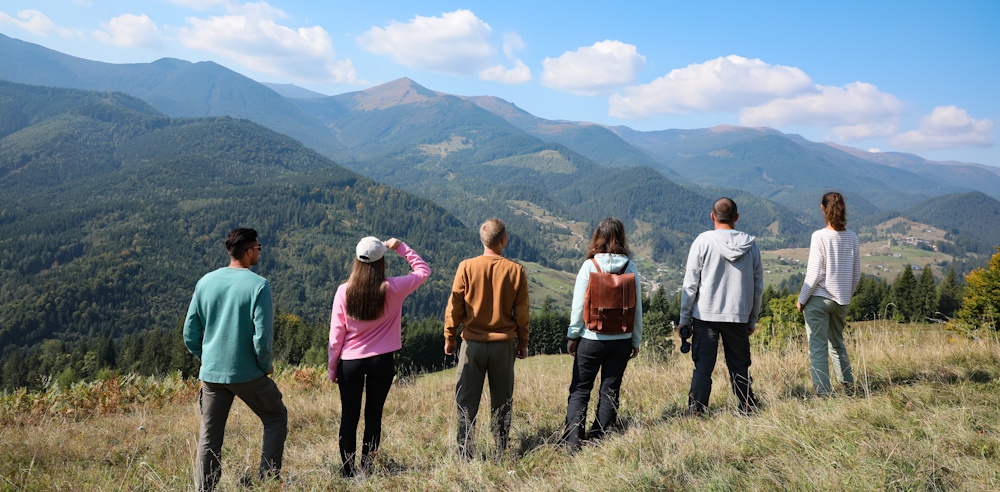 group hiking overlooking mountains